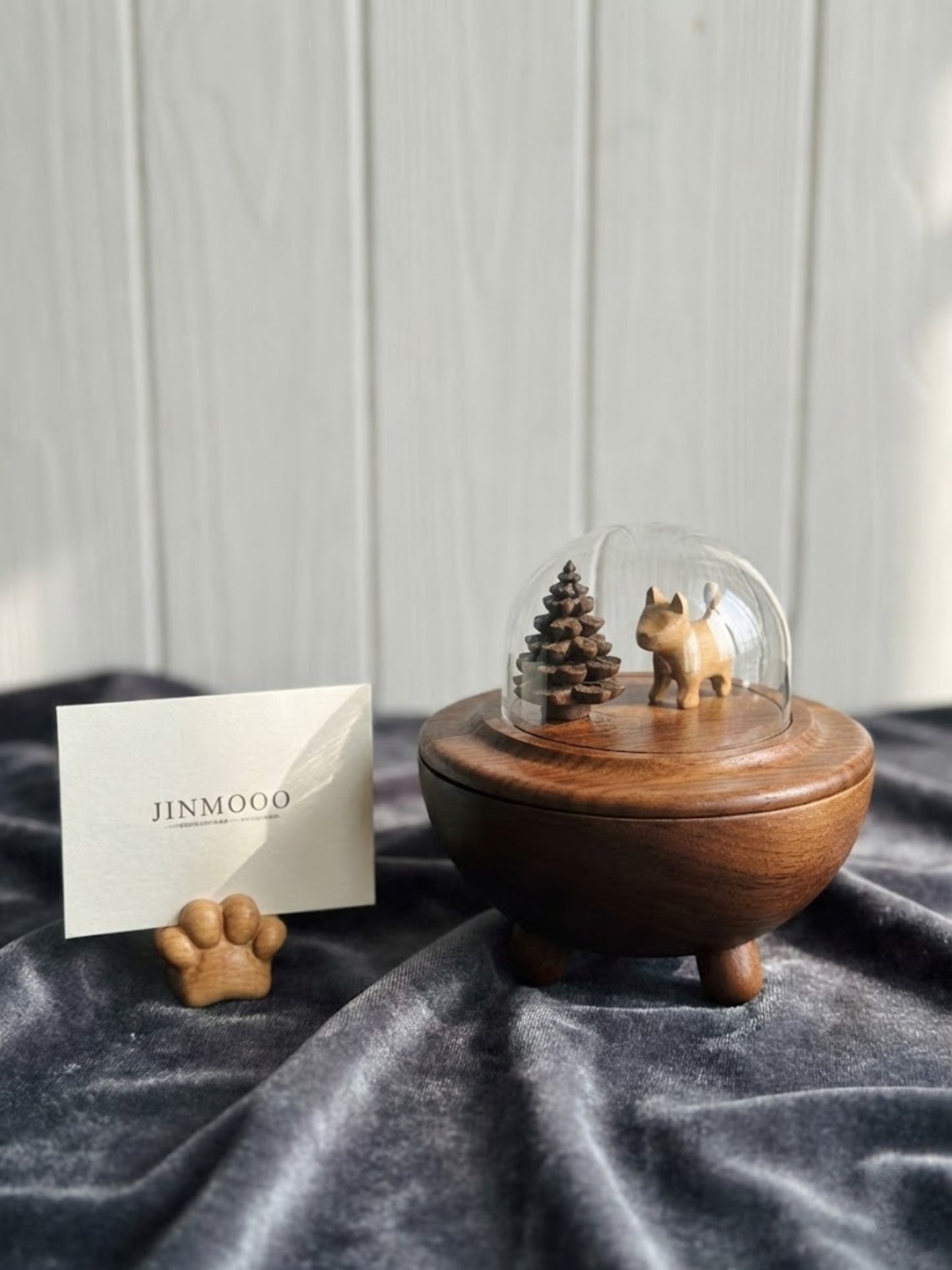Et vakkert urne for hund i tre med et lite tre og hundefigur under en glasskuppel, vist med en symbolsk regnbue-effekt.